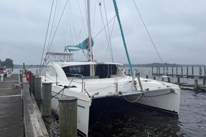 Leopard 48 2013 Leopard 48 catamaran docked at a marina on a cloudy day.