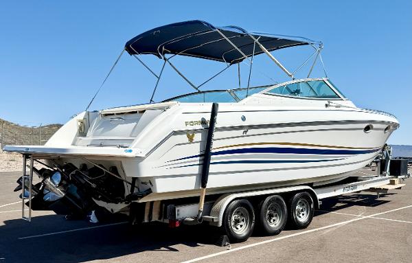 Formula 330 Sun Sport 2000 Formula 330 Sun Sport boat on trailer, featuring sleek design and blue accents.