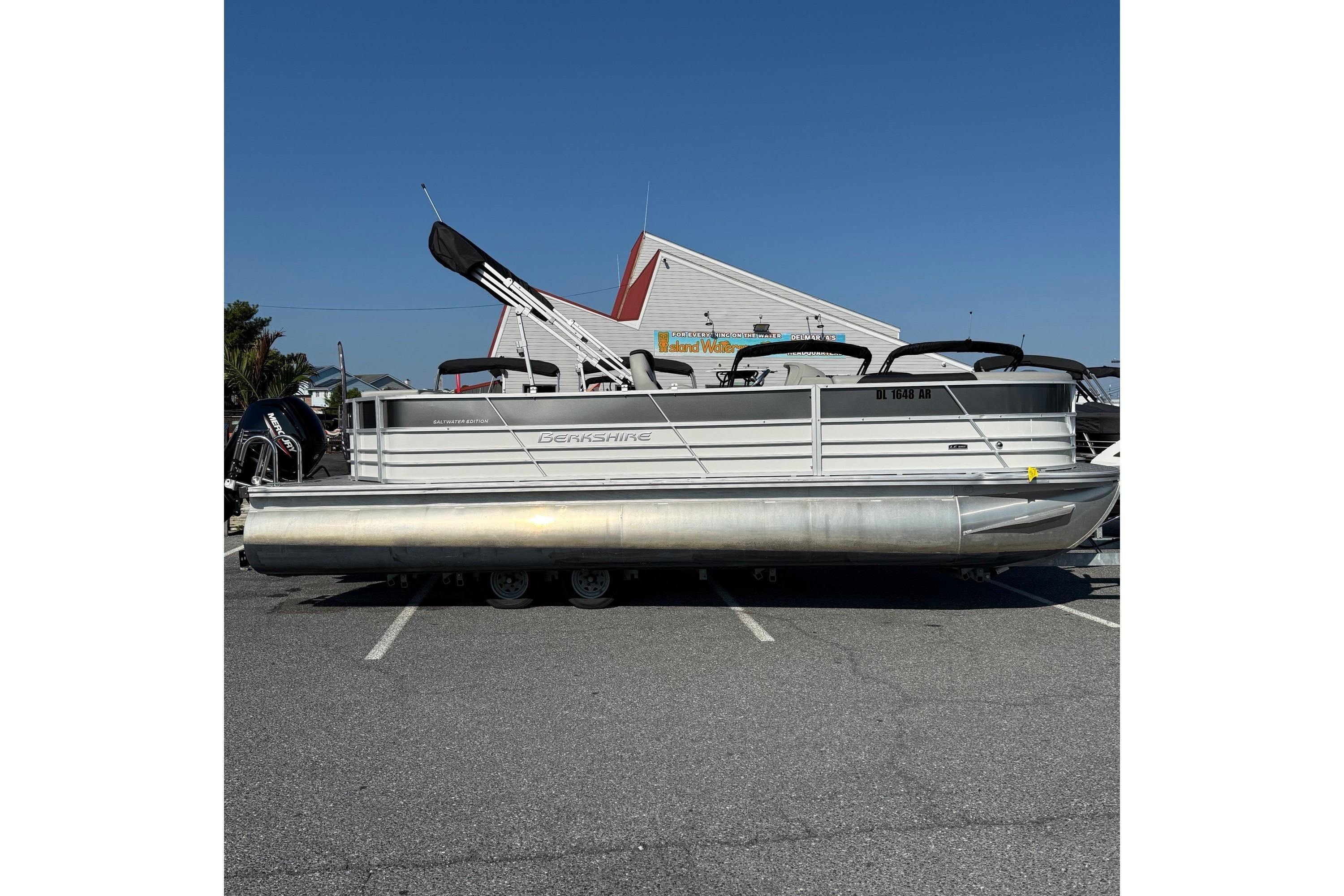 Berkshire 24CL 2.75 LE 2025 Berkshire 24CL 2.75 LE pontoon boat parked outdoors under clear blue sky.