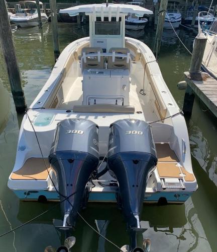 NauticStar 28 XS Offshore 2020 NauticStar 28 XS Offshore boat with dual 300 horsepower engines docked in marina.