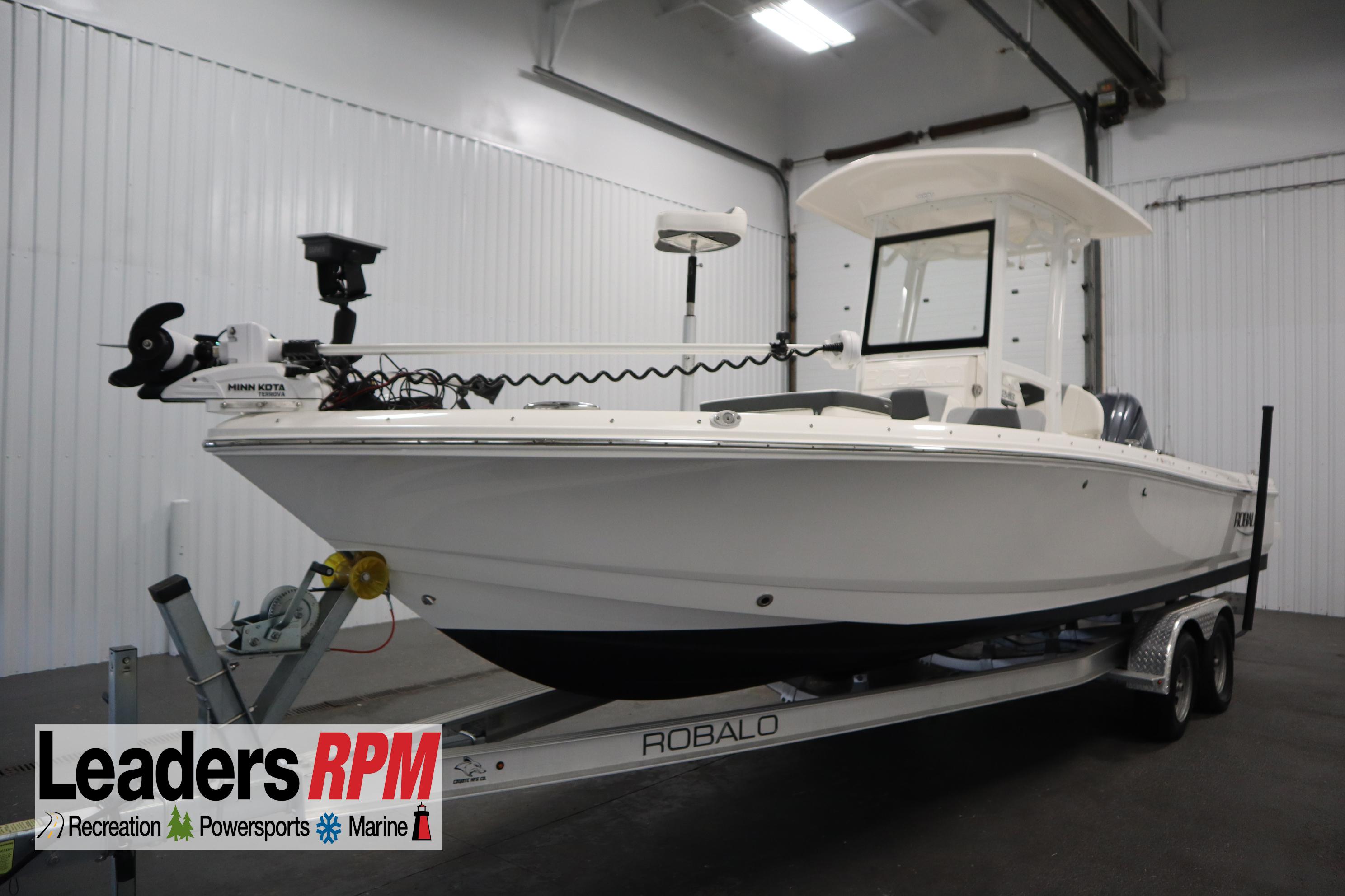 Robalo 246 Cayman 2022 Robalo 246 Cayman boat on trailer in indoor showroom.