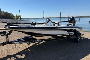 Nitro Z18 Pro 2016 Nitro Z18 Pro boat on trailer by a lake under clear blue sky.