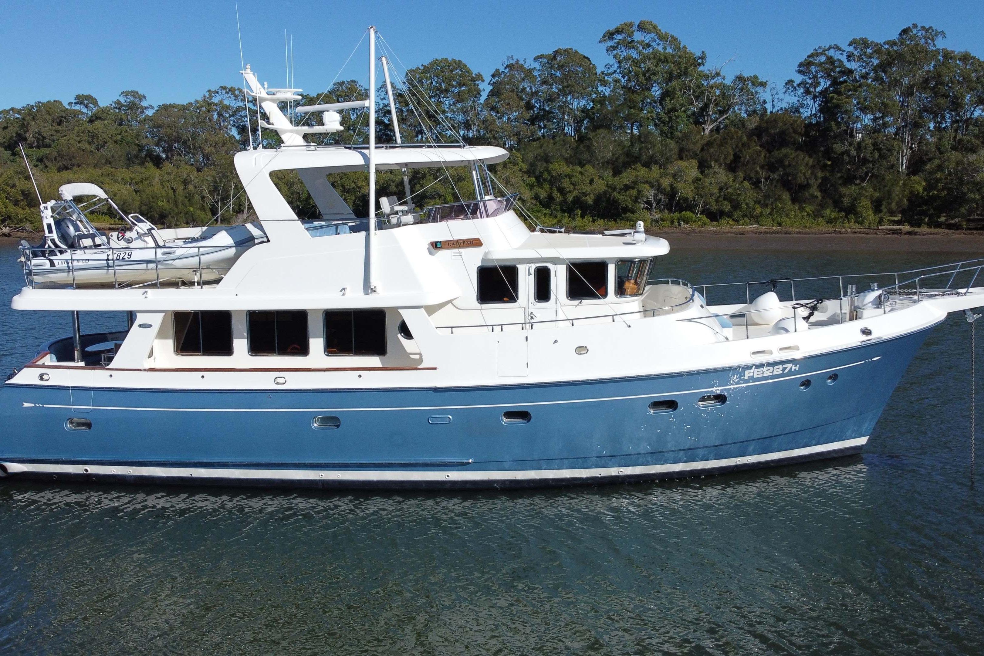 Selene 59 Ocean Trawler 2008 Selene 59 Ocean Trawler yacht on calm water, surrounded by lush greenery.