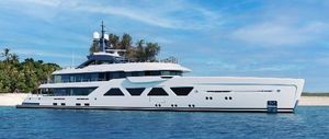 Amels 60 Luxury Amels 60 yacht, 2025 model, cruising near a tropical island under a clear blue sky.