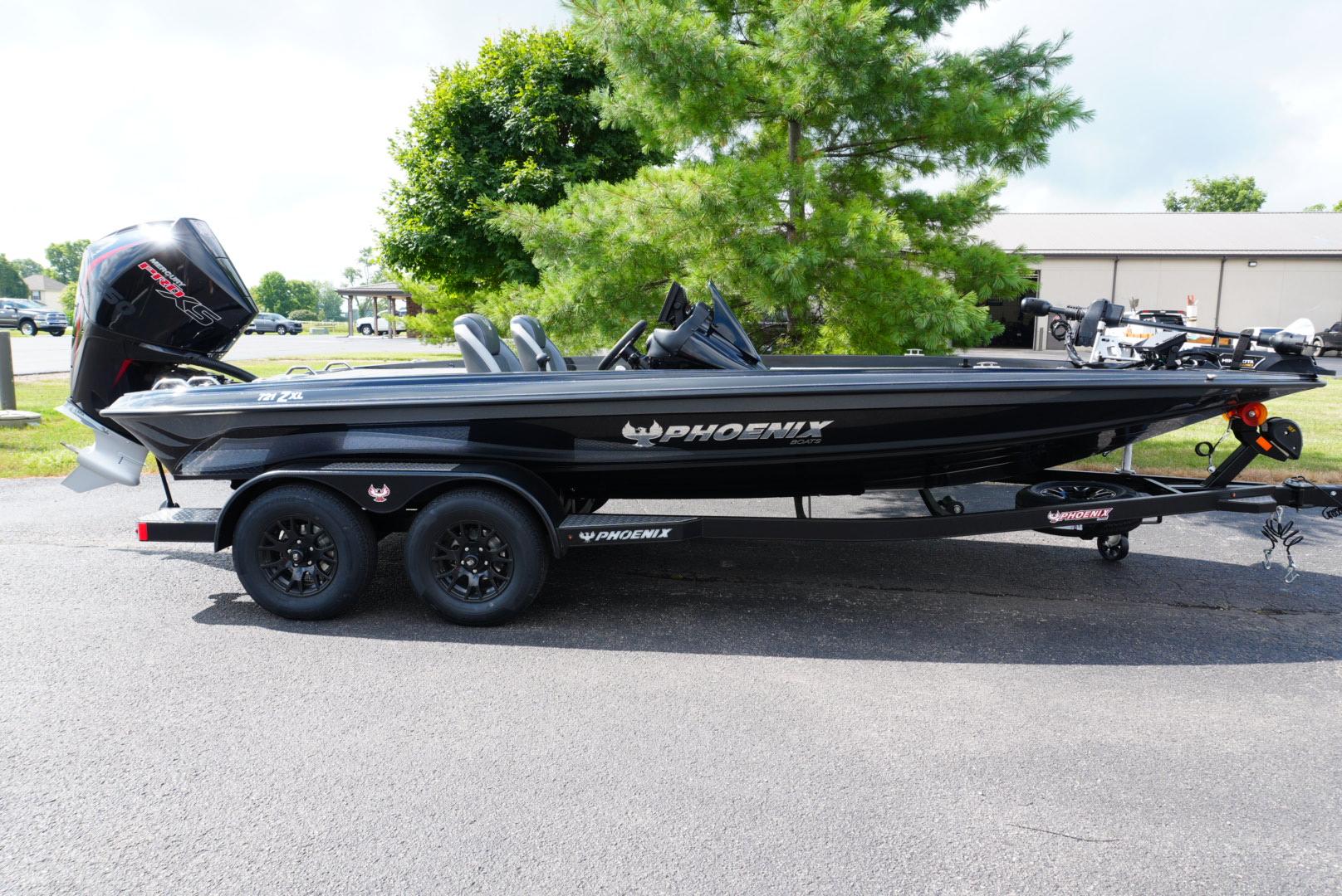 Phoenix 721 ZXL 2026 Phoenix 721 ZXL boat on trailer, parked outdoors near trees.