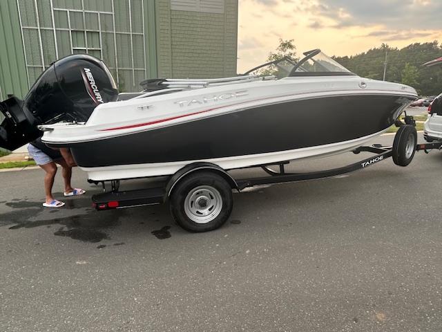 Tahoe 185 S 2023 Tahoe 185 S boat on trailer, parked outdoors near a building.