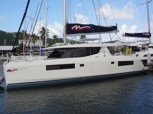 Leopard 45 2020 Leopard 45 catamaran docked in marina, featuring sleek design and modern sails.