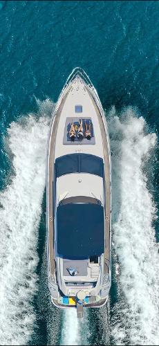 Azimut 58 Fly Aerial view of 2001 Azimut 58 Fly yacht cruising on blue ocean waters.