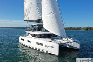 Lagoon 46 2024 Lagoon 46 catamaran sailing on a clear blue sea under sunny skies.