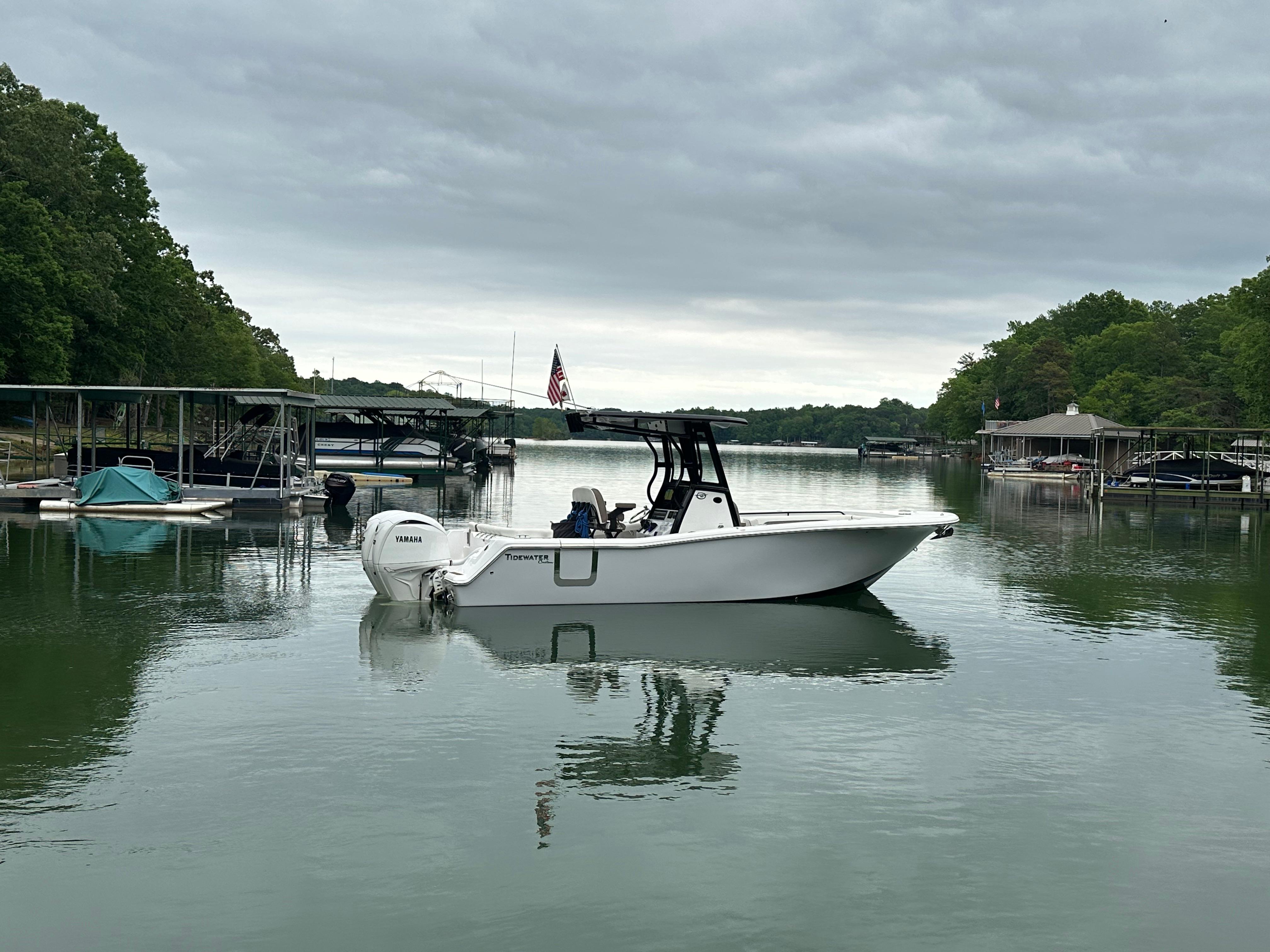 Tidewater 256 LXF 2025 Tidewater 256 LXF boat docked on a calm lake under cloudy skies.