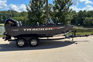Tracker Pro Guide V-175 Combo 2026 Tracker Pro Guide V-175 Combo boat on trailer, parked outdoors near a lake.