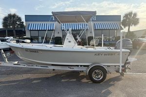 Key West 1720 Center Console 2023 Key West 1720 Center Console boat on trailer, parked outside a building.