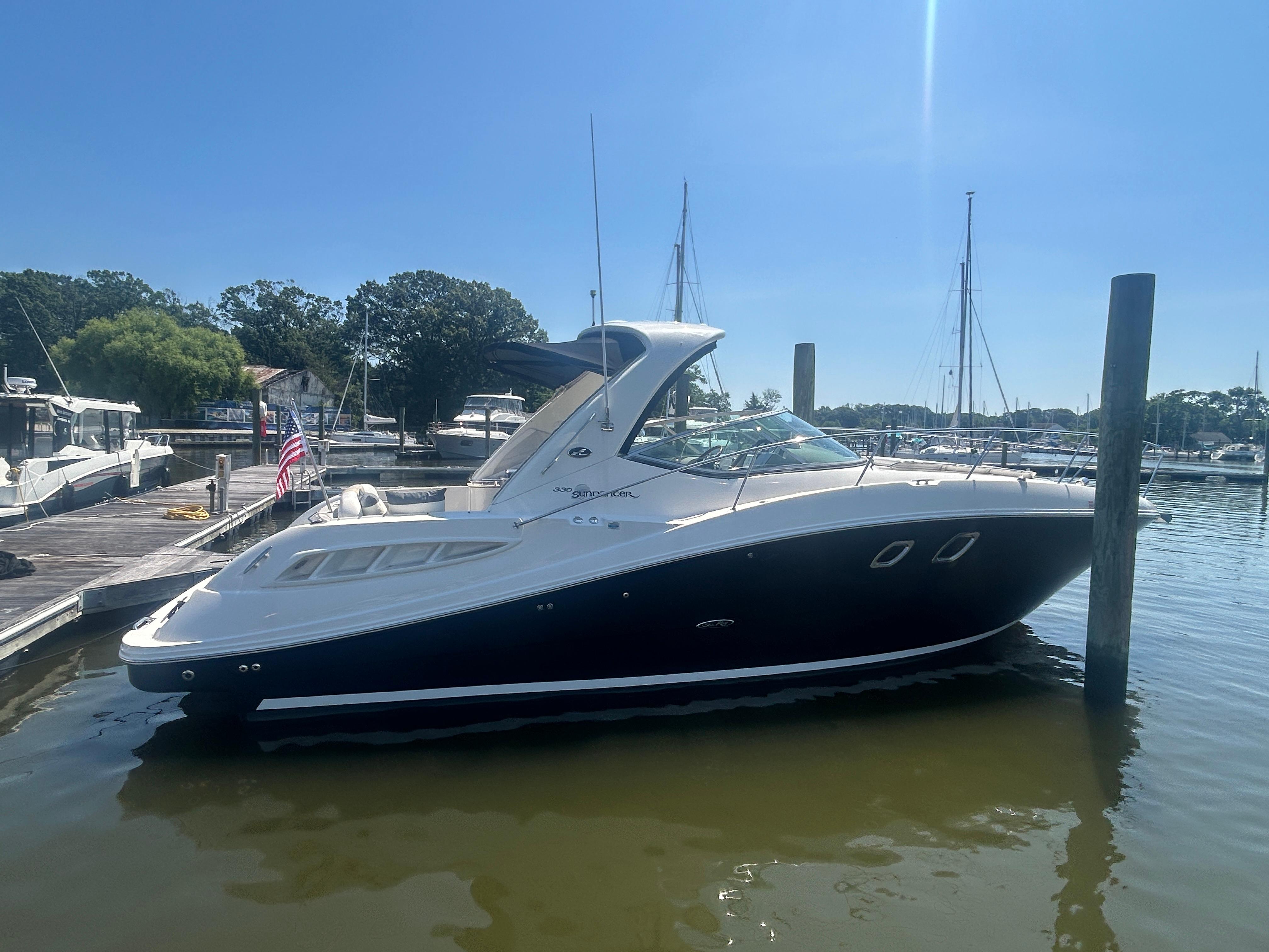 Sea Ray 330 Sundancer 2008 Sea Ray 330 Sundancer docked at a marina under clear blue skies.