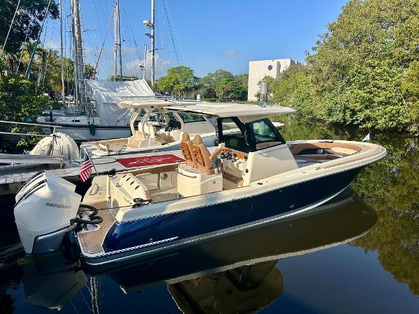 Chris-Craft 31 catalina 2025 Chris-Craft Catalina boat docked on calm water, surrounded by lush greenery.