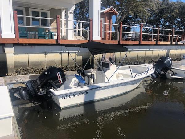 May-Craft 1800 Skiff 2021 May-Craft 1800 Skiff boat named Tide Runner docked by a waterfront house.