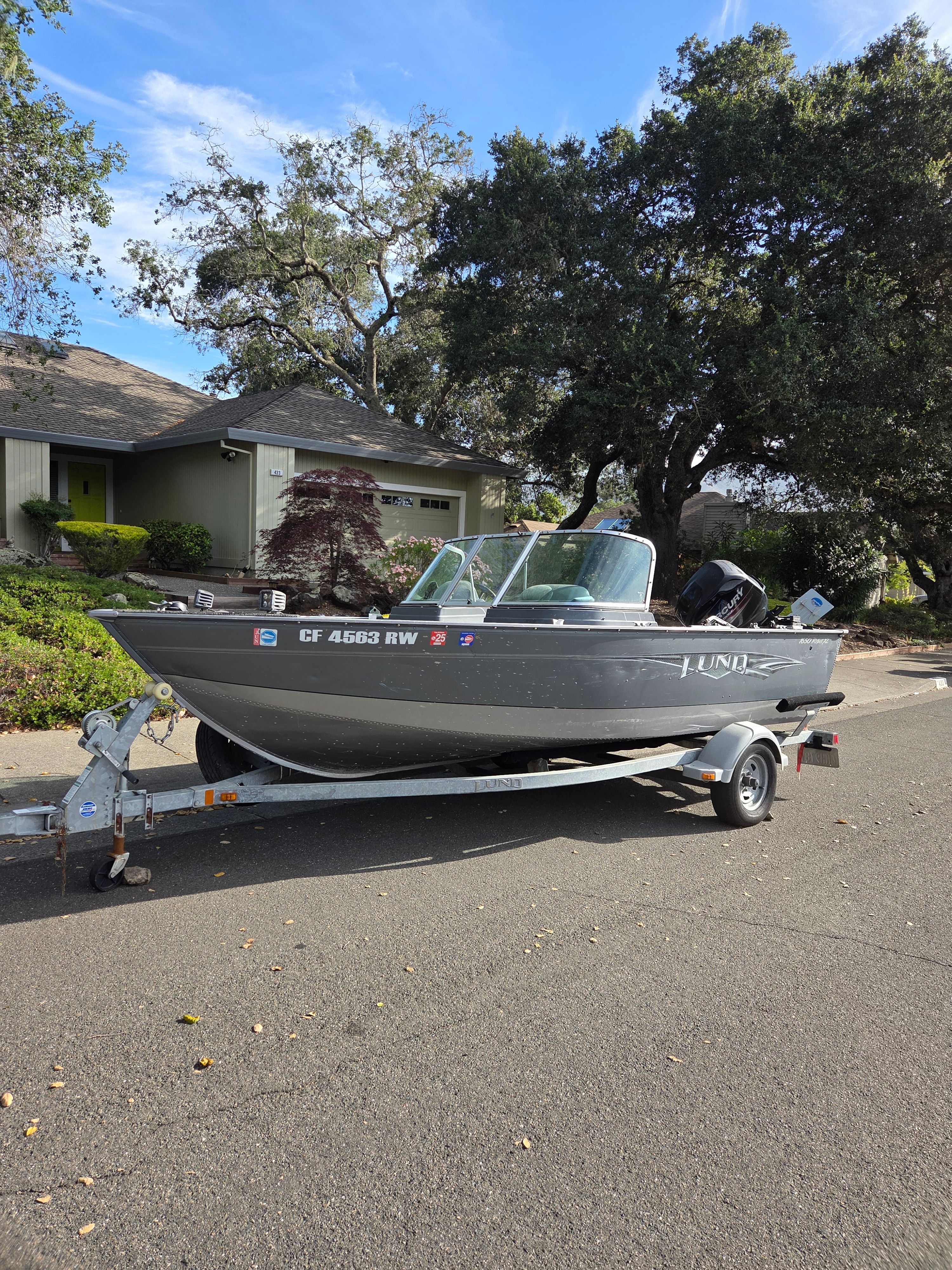 Lund 1650 Rebel XL Sport 2014 Lund 1650 Rebel XL Sport boat on trailer, parked on residential street.