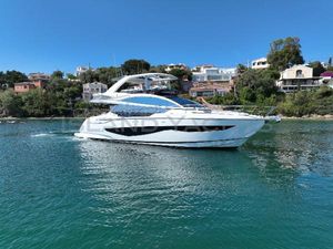 Pearl 62 Luxurious 2020 Pearl 62 yacht cruising on serene waters near coastal homes.