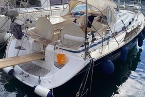 Bavaria 50 2005 Bavaria 50 sailboat docked, featuring a spacious deck and protective canopy.