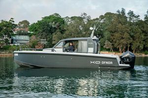 XO Boats DFNDR 9 2022 XO Boats DFNDR 9 cruising on a calm lake with lush greenery in the background.