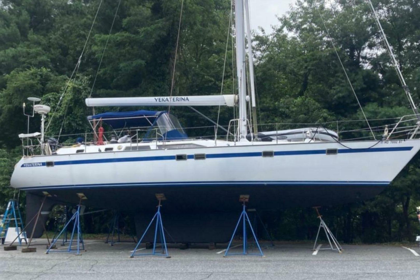 Taswell 49 1989 Taswell 49 sailboat on stands, surrounded by trees.