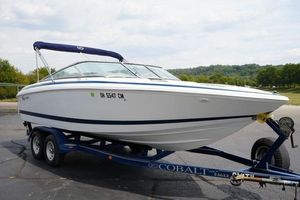 Cobalt 226 2000 Cobalt 226 boat on trailer, parked outdoors with scenic background.
