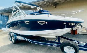 Cobalt 243 2012 Cobalt 243 boat on trailer, blue and white, parked outdoors.