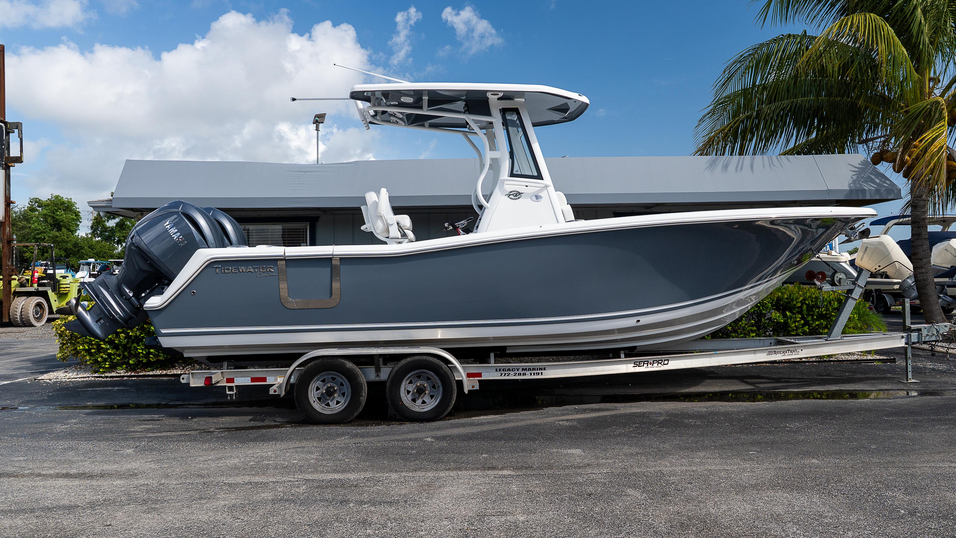 Tidewater 256 CC Adventure 2026 Tidewater 256 CC Adventure boat on trailer, parked outdoors near palm tree.