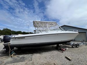 Contender 35 Side Console 2005 Contender 35 Side Console boat on trailer, parked outdoors under cloudy sky.