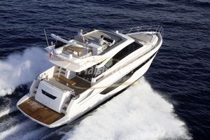 Cayman Yachts F520 Luxurious 2019 CAYMAN F520 yacht cruising on open sea, aerial view.