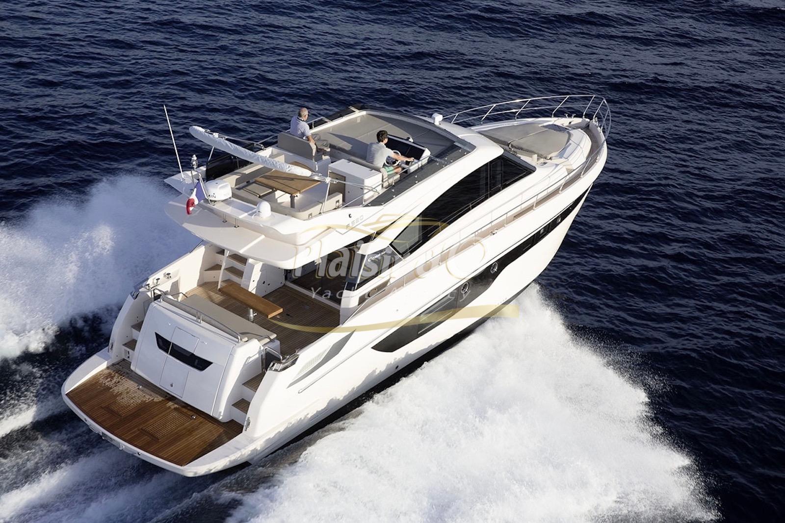 Cayman Yachts F520 Luxurious 2019 CAYMAN F520 yacht cruising on open sea, aerial view.