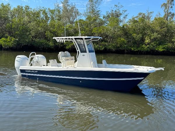 World Cat 235 CC 2025 World Cat 235 CC boat on calm water, surrounded by lush greenery.
