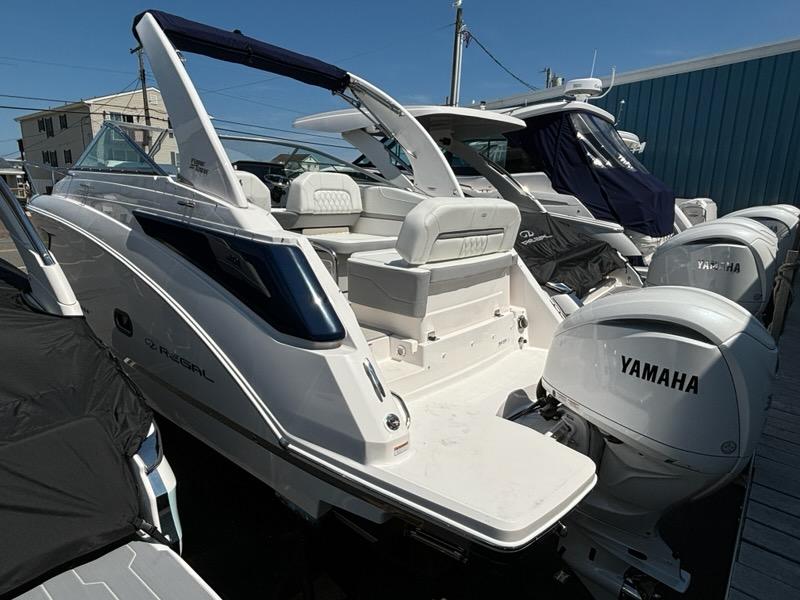 Regal 26 XO 2026 Regal 26 XO boat with Yamaha engines, docked in a marina.