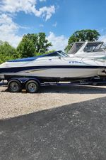Chaparral 205 SSe Chaparral 2000 200SSI boat on trailer, parked outdoors on a sunny day.