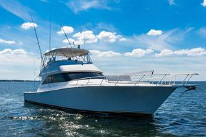 Viking 56 Convertible 2006 Viking 56 Convertible yacht cruising on open water under a clear blue sky.