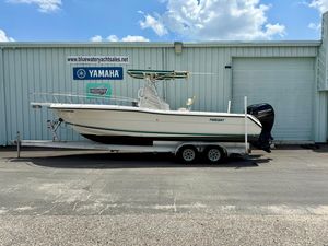Pursuit 2470 Center Console 1997 Pursuit 2470 Center Console boat on trailer, parked outside dealership.