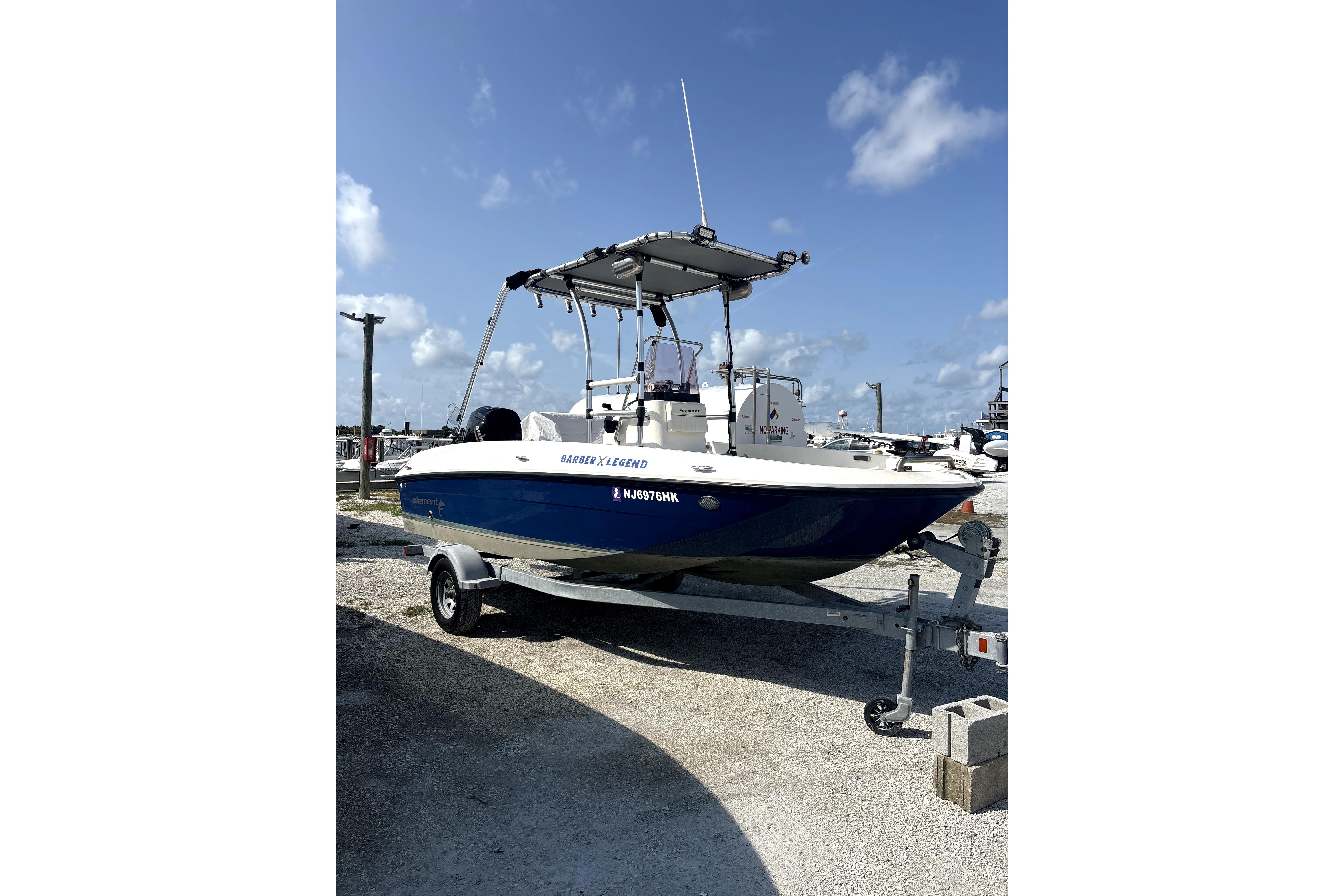 Bayliner Element F18 2020 Bayliner Element F18 boat on trailer under clear blue sky.