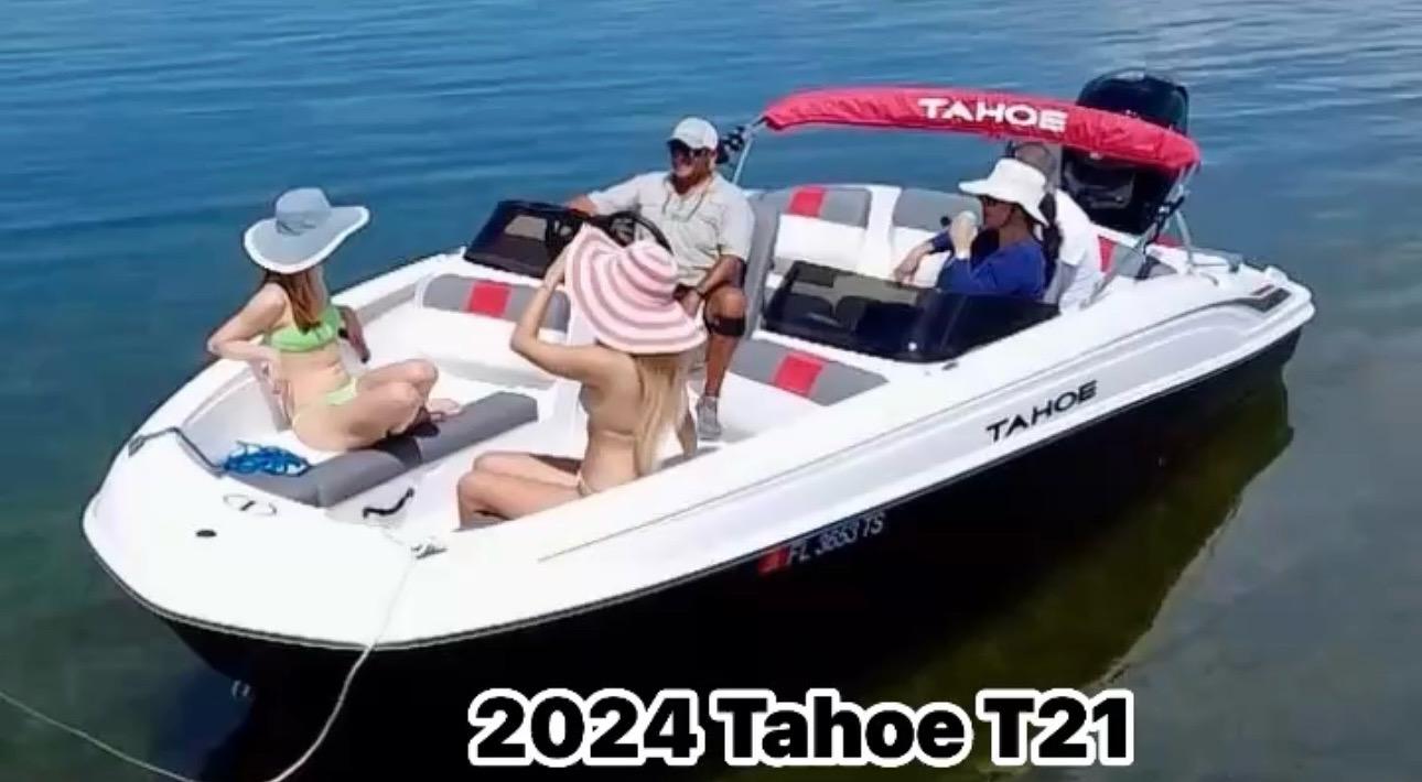 Tahoe T21 2024 Tahoe T21 boat with passengers relaxing on calm water.