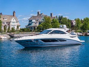 Sea Ray 510 Sundancer 2015 Sea Ray 510 Sundancer yacht cruising near waterfront homes.