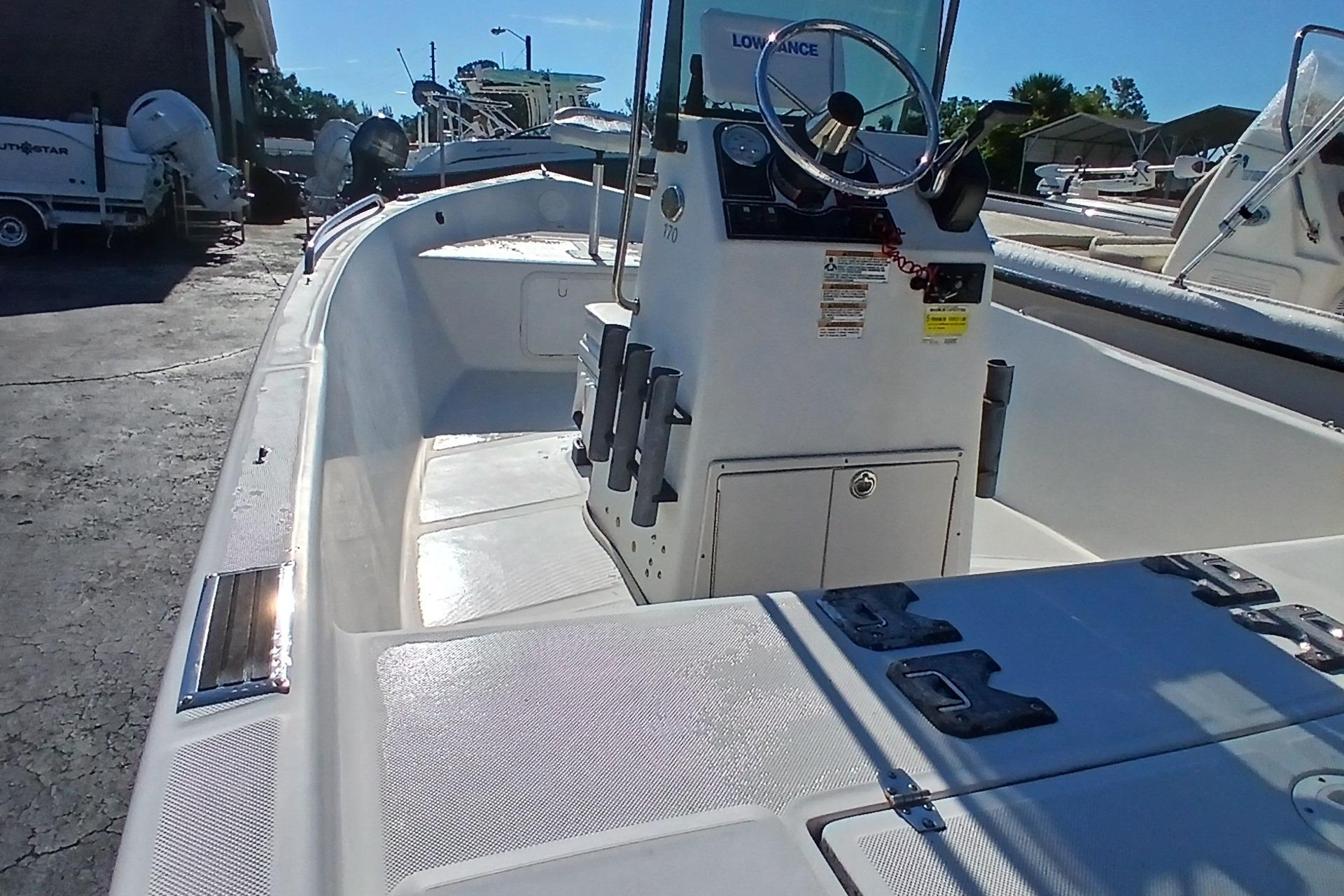 Starcraft 170 2015 Starcraft 170 boat interior with steering console and storage compartments.