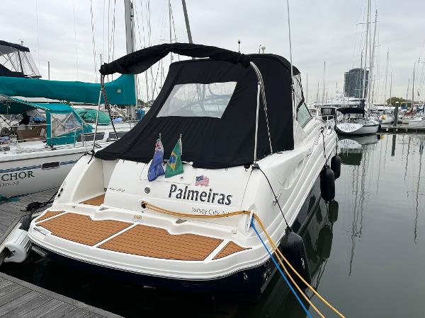 Sea Ray 340 Sundancer 2006 Sea Ray 340 Sundancer yacht docked, featuring black canopy and wooden deck.