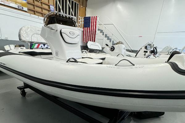 Walker Bay Gen 13 LTE 2024 Walker Bay Gen 13 LTE inflatable boat in showroom with American flag backdrop.