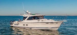 Cutwater C-302 Coupe 2019 Cutwater C-302 Coupe cruising on open water under clear blue skies.
