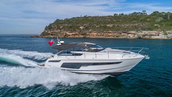 Fairline Targa 50 GT 2025 Fairline Targa 50 GT luxury yacht cruising near a rocky coastline.