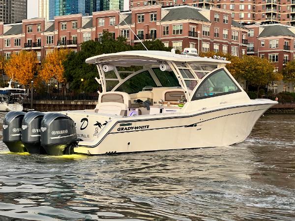Grady-White Freedom 375 2014 Grady-White Freedom 375 boat with triple Yamaha engines on urban waterfront.