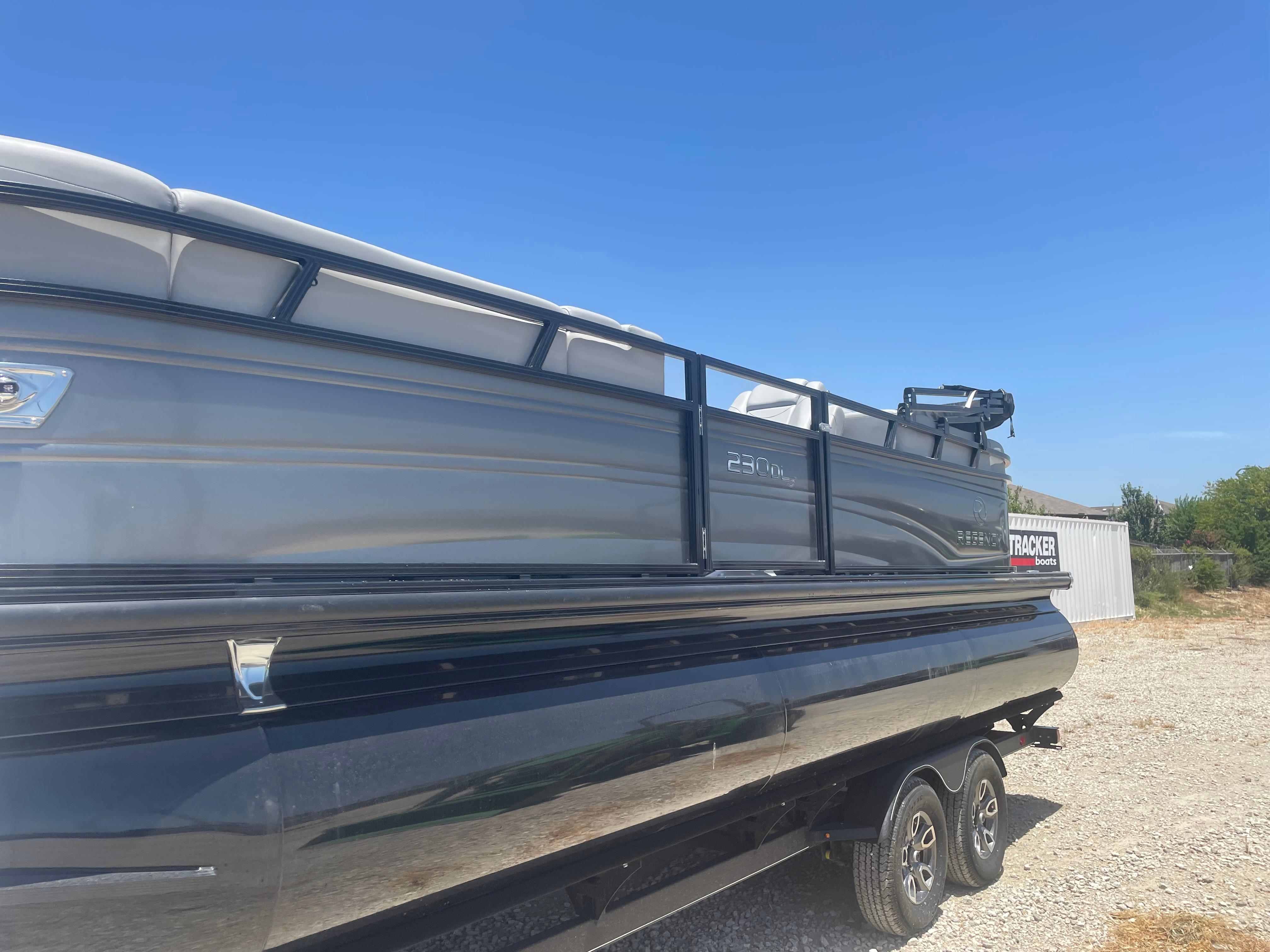 Regency 230 DL3 2024 Regency 230 DL3 pontoon boat on trailer under clear blue sky.
