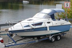 Aqualine 690 2020 Aqualine 690 boat on trailer by riverside, featuring "Blue Bay" design.
