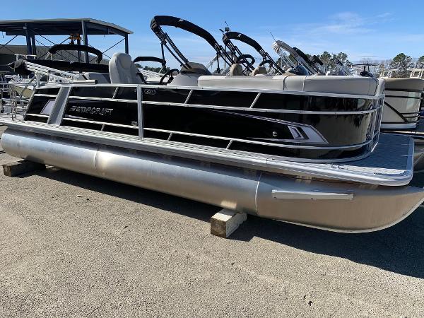 Starcraft EX22Q 2024 Starcraft EX22Q pontoon boat on display at a marina.