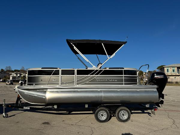 South Bay 220 RS LE 2025 South Bay 220 RS LE pontoon boat on trailer, sunny day.