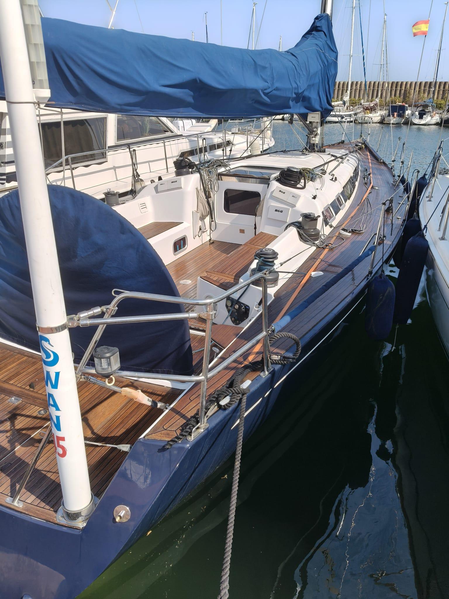 Nautor Swan 45 Nautor Swan 45 sailboat, 2003 model, docked in a marina with blue sail cover.