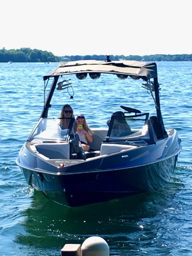 Axis T23 2015 Axis T23 boat on a sunny lake with two passengers onboard.